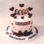 The light pink base of this Blackpink Birthday Cake serves as a canvas for their dynamic energy, while the sleek black ribbon at the bottom symbolises their sophistication and style.