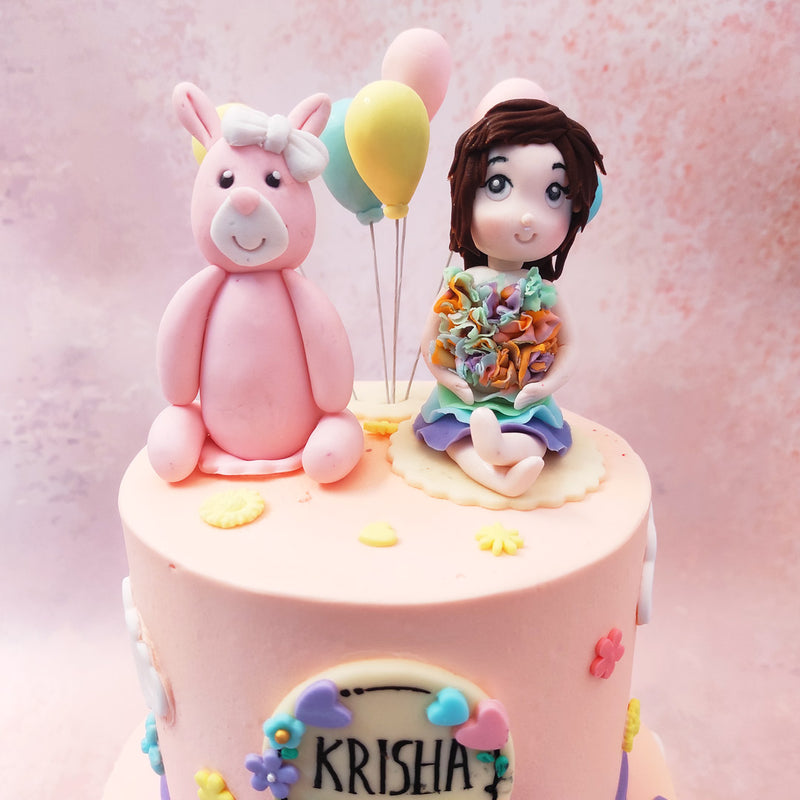 Both tiers of this two tier bunny unicorn cake comes in a pink colour palette, the same shade of a little girl's room or nursery, yet this girl bunny birthday cake is still set in the great outdoors, with rolling green hills, flowers, birds and bows embellishing it.