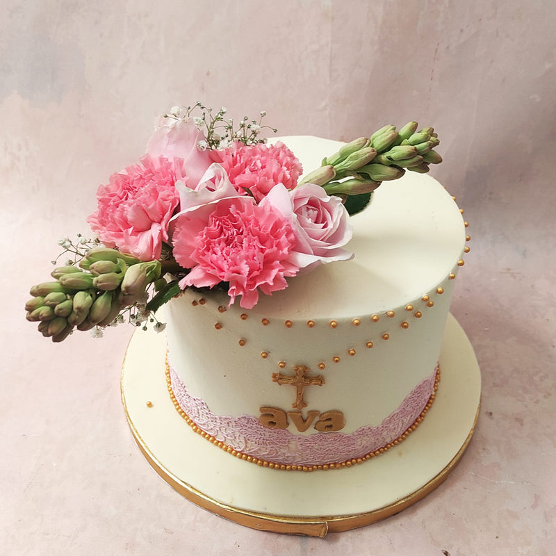 Edible pink lace, soft and delicate, adorns the base of this Gold Cross Cake, symbolising purity and the gentle embrace of spiritual guidance. 