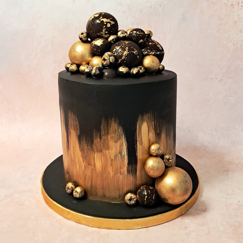 This golden and black cake design is a stunning blend of black and gold, exuding an air of luxury and elegance. The contrasting colors create a visually striking effect, capturing attention from every angle. 