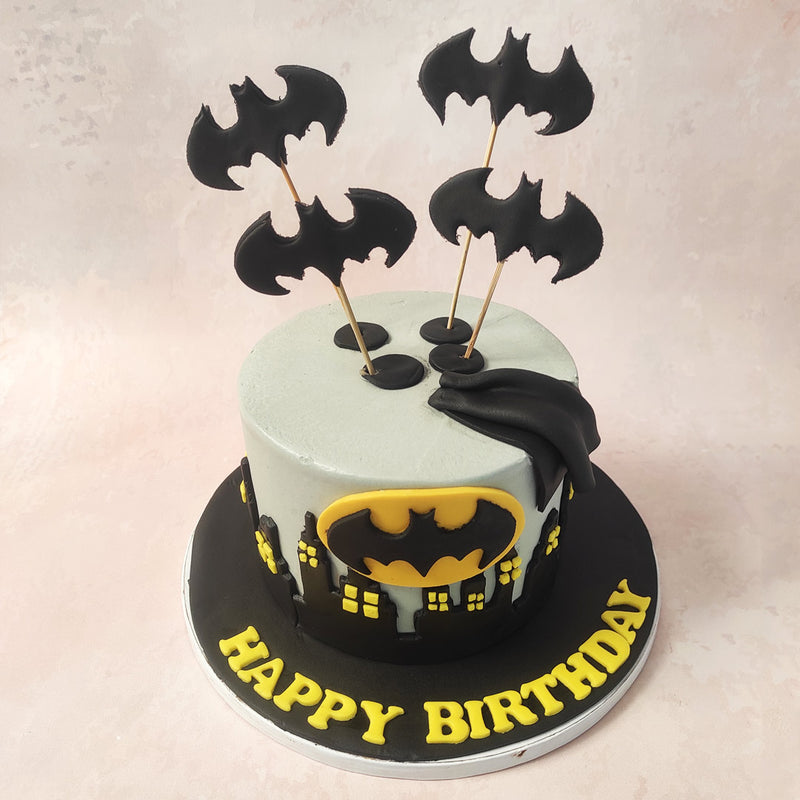 At its heart of this Batman Cake lies the iconic Batman logo and his cape, a symbol of vigilance and heroism. 