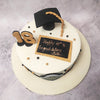 Atop the simple graduation cake sits a magnificent graduation hat, an iconic symbol of academic accomplishment.