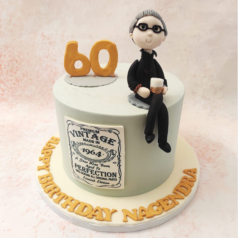 The centrepiece of this Grandfather Theme Cake is a figure of a distinguished gentleman, holding a drink, perhaps reminiscing on the years gone by. 