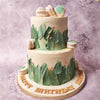 The strokes of green buttercream on this white and green macaron cake are artfully applied in an abstract manner, resembling lush leaves swaying in a gentle tropical breeze. 