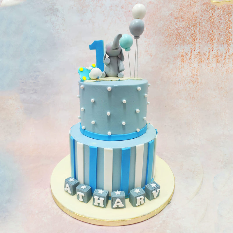 This Grey Elephant Theme Cake brings childlike wonder to life, while the baby blue striped design creates a sophisticated yet playful foundation for a memorable first celebration. 