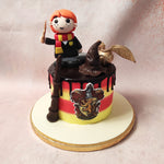 Featuring horizontal stripes in the iconic red and yellow colours, this Ron Weasley cake is adorned with a rich, chocolate drip frosting, adding a touch of decadence to the design.
