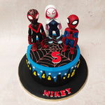 Atop the blue expanse of this Gwen Stacy Cake metropolis rests not one but three guardians of good taste: Spiderman, Gwen Stacy, and Miles Morales.
