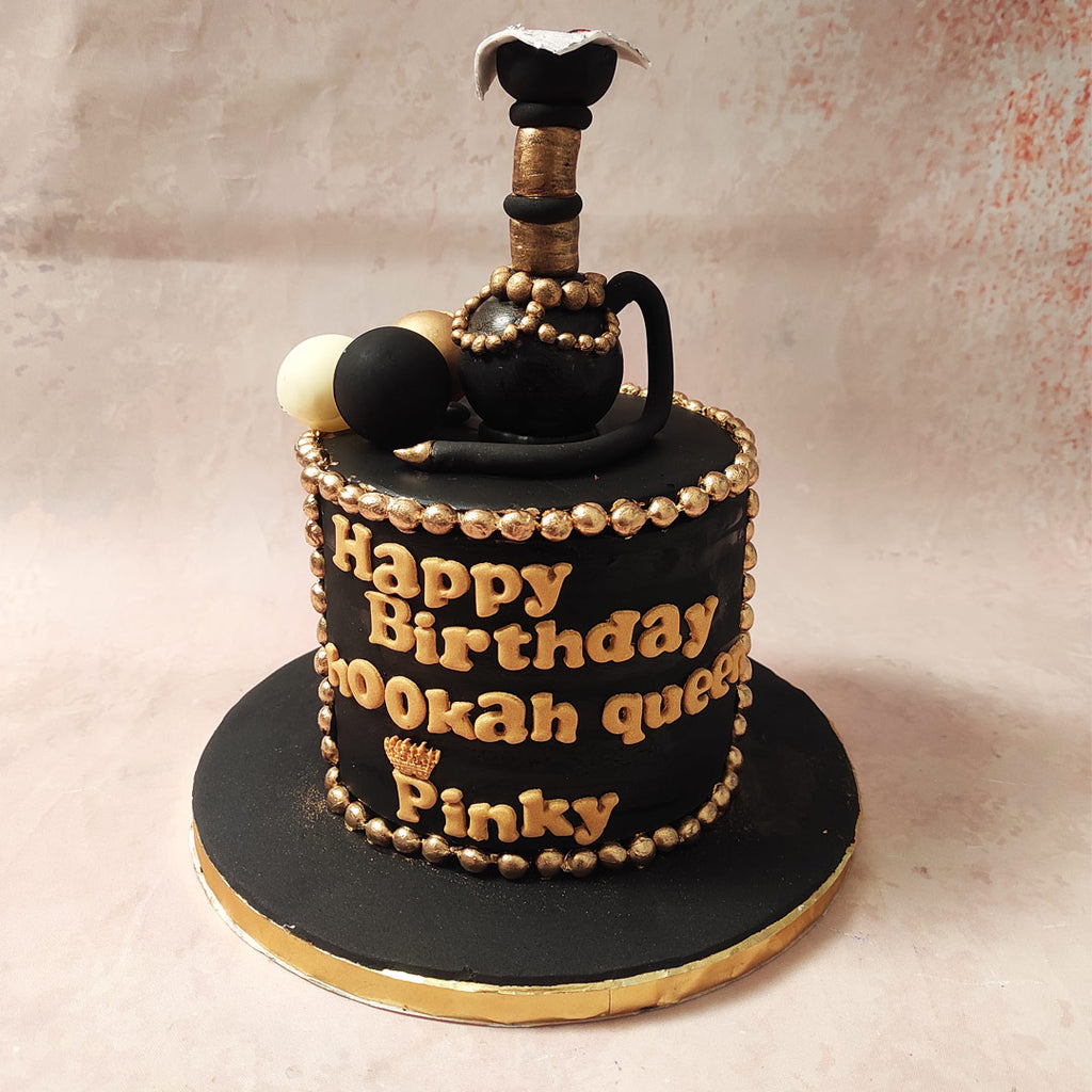 The top of this Shisha cake is embellished with playful black, white and gold baubles, reminiscent of swirling smoke rings.  But what makes this smoking cake truly stand out is its centrepiece - an edible figurine of a hookah pot, crafted with utmost precision and attention to detail. 