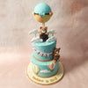 Edible figurines of hot air balloons, suspended in sugary flight, drift across the Sky Theme Cake, adding a whimsical touch. 