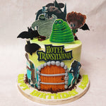 The base of this Hotel Transylvania 2 cake, a striking blend of white and green, represents the enchanting landscape surrounding the hotel. 