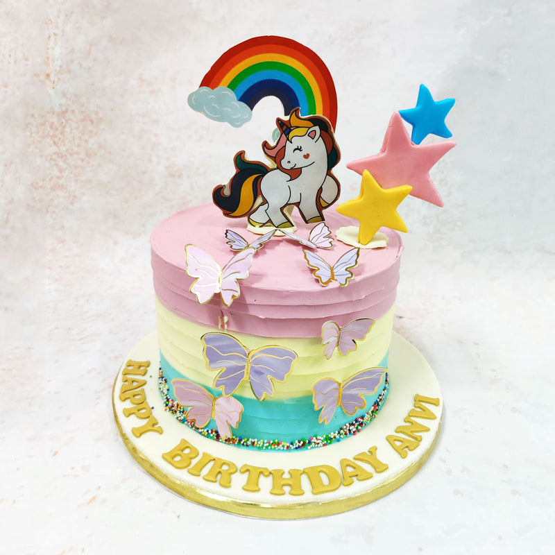 At the heart of this Layered Unicorn Cake stands a charming unicorn figurine, its soft pastel coat and playful expression capturing the eternal allure of these mythical creatures that have long captured the hearts and minds of young ones.