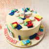 The pastel tones of blue, green, yellow, and red add a soft, yet vibrant touch, ensuring this Lego Birthday Cake remains light-hearted and inviting.