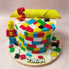 Edible LEGO blocks, each a miniature marvel of colour and detail, adorn the surface of this Lego Man Cake in a riot of hues, evoking the playful spirit of childhood imagination.