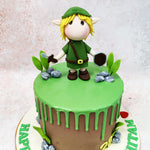 Atop this Link Zelda Cake stands an adorable rendition of Link, Hyrule’s courageous hero, complete with his iconic green tunic, pointed ears, and blonde hair. The figurine clutches the Master Sword and Hylian Shield, ready to embark on his quest to defeat Ganon and save Princess Zelda, capturing the essence of the adventure that has enchanted gamers for generations.
