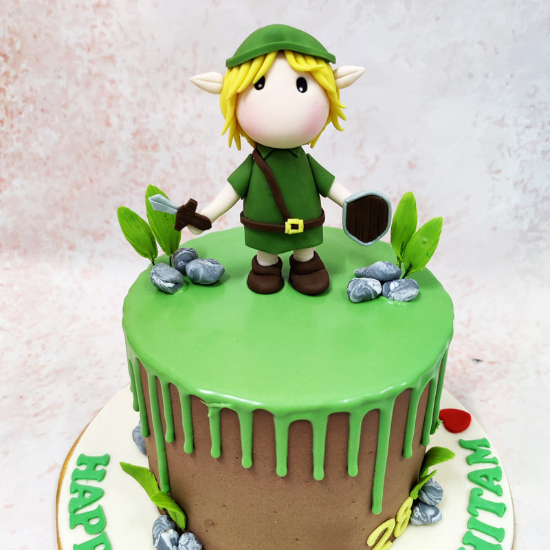 Atop this Link Zelda Cake stands an adorable rendition of Link, Hyrule’s courageous hero, complete with his iconic green tunic, pointed ears, and blonde hair. The figurine clutches the Master Sword and Hylian Shield, ready to embark on his quest to defeat Ganon and save Princess Zelda, capturing the essence of the adventure that has enchanted gamers for generations.
