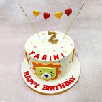 The front of this Lion Birthday Cake features a sweet lion face framed in a soft orange mane, with button eyes and a tiny heart-shaped nose that instantly gives it a friendly, storybook vibe.