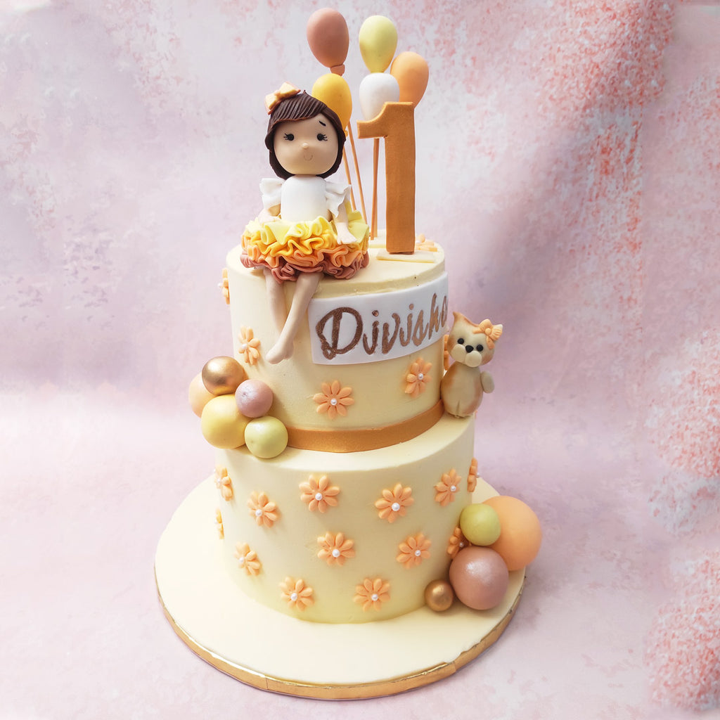 The first tier of this floral balloon cake is adorned with meticulously crafted orange buttercream flowers, symbolising the beauty and vibrancy of life. 