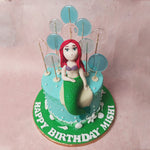 Atop this Lollipop Cake, a figurine resembling Ariel, the iconic mermaid, beckons you into a world where myth and reality intertwine.