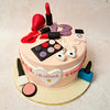 The centrepiece of this make up theme cake is a meticulously crafted eyeshadow palette, complete with vibrant hues that pop against the soft pink backdrop. Bottles of spilled nail polish add a touch of drama to the design of this Makeup cake, while a glistening lipstick and blush capture the essence of femininity and elegance. 