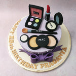 This MAC theme cake is set on a purple base resembling a cake display stand, embellished with edible pearls and a large purple bow wrapped around its border.