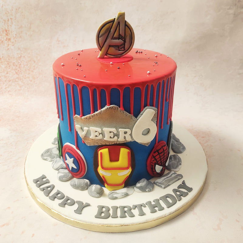 This Marvel Avengers Cake is adorned with detailed decorations, including Iron Man's mask, Captain America's shield, and Spider-Man's emblem, each meticulously crafted to capture the essence of these beloved characters.