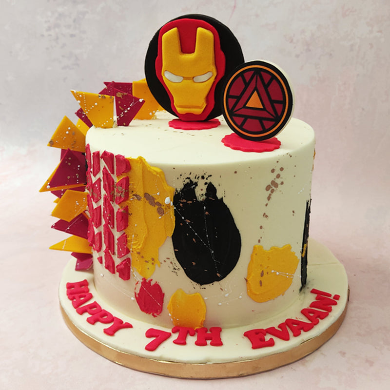 Iron Man's mask is embedded into the top of this Marvel cake next to a three dimensional replica of his famous arc reactor. 