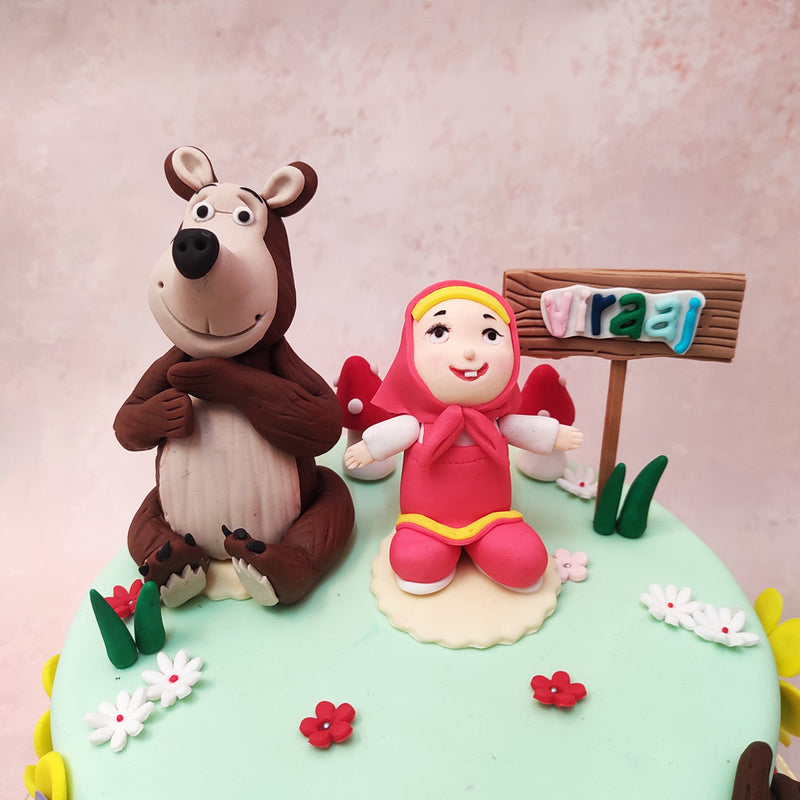 Miniature, edible figurines of Masha and The Bear have been recreated and rest on top of this Masha and The Bear cake bringing the world of the show even more to life with the characters that make it so special and memorable.