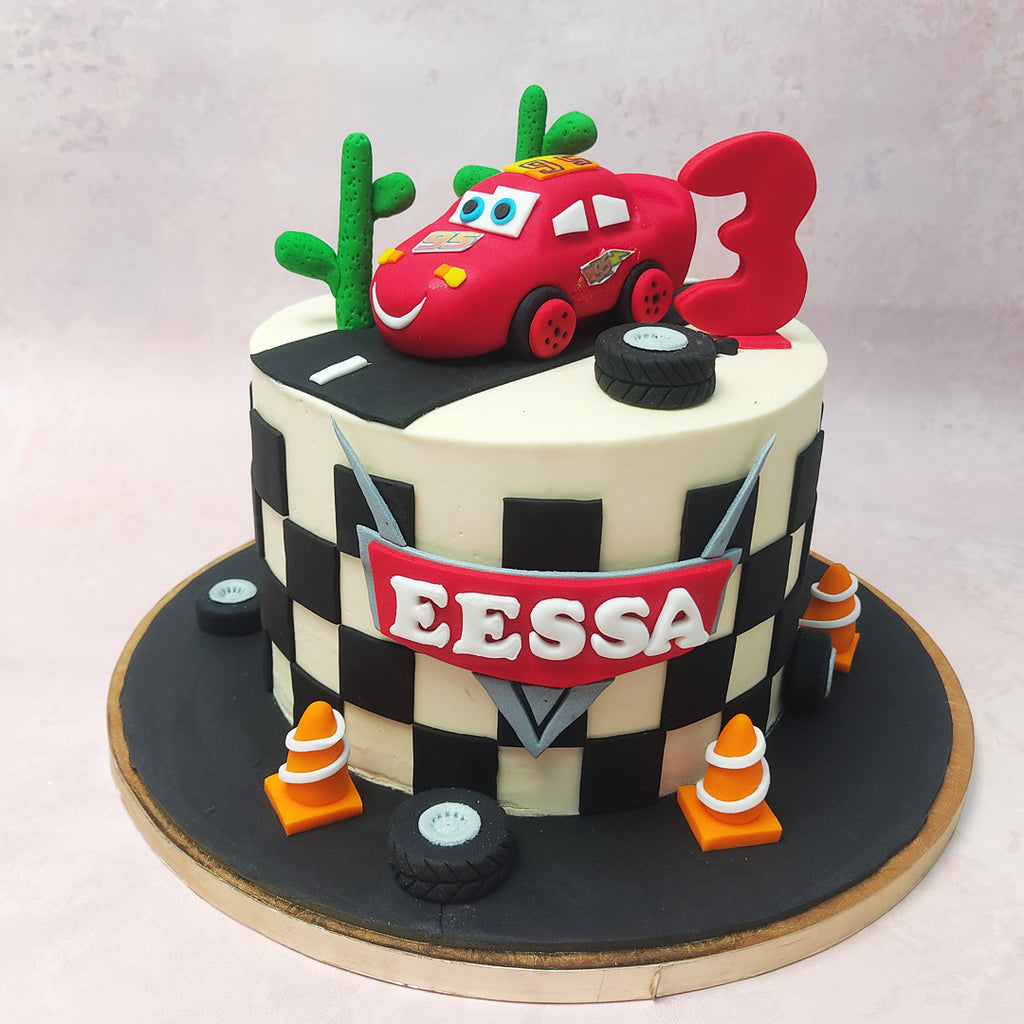 Amidst the desert landscape recreated on this  Lightning McQueen Car Racing Cake, cacti stand tall, silent witnesses to Lightning's epic journey, while a trusty tire reminds us of the trials and triumphs of the open road.