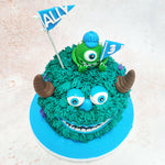 Atop this Mike and Sully Cake sits the ever-watchful Mike, the one-eyed green monster, holding festive flags that celebrate the occasion with his characteristic enthusiasm.