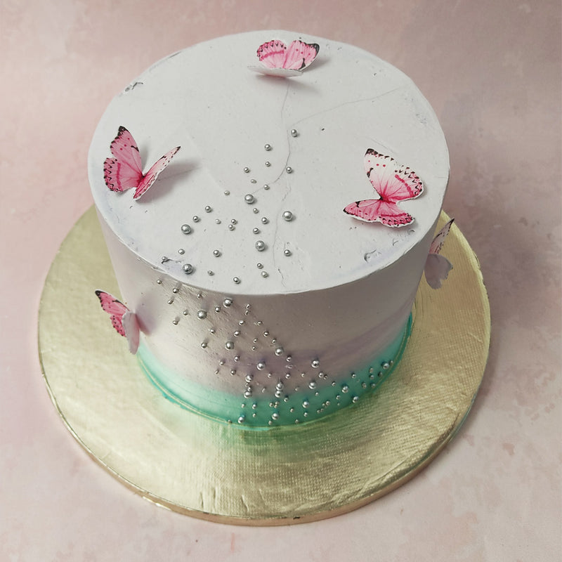 Each delicate silver pearl on this minimalist cake butterfly design symbolises the precious moments shared with your beloved wife, representing the cherished memories that have been woven into the fabric of your relationship, making it perfect as a birthday cake for wife.