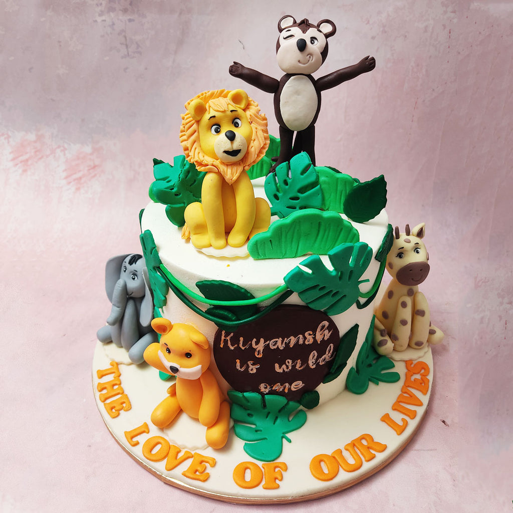 Picture a pristine white base adorned with vivid tropical green leaves, evoking the dense foliage of the jungle canopy and you’ll get a glimpse of our Monkey Theme Cake