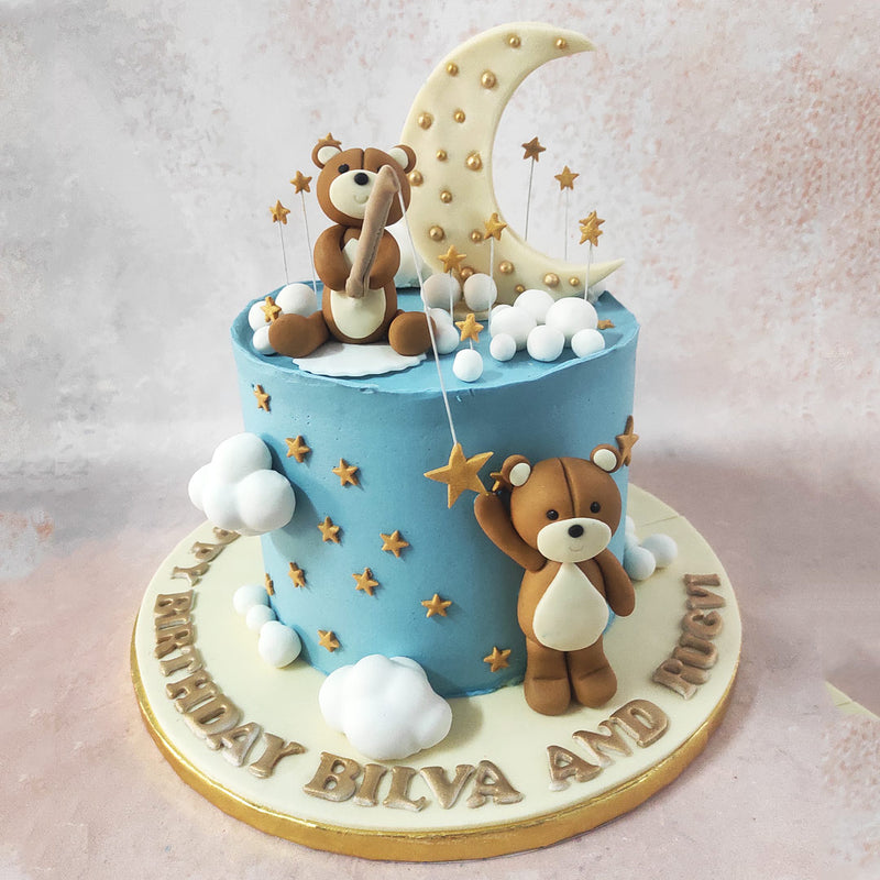 The celestial masterpiece that is this moon cake teddy design features a sky blue base adorned with gold stars and puffy white clouds, creating a dreamy and ethereal atmosphere. 