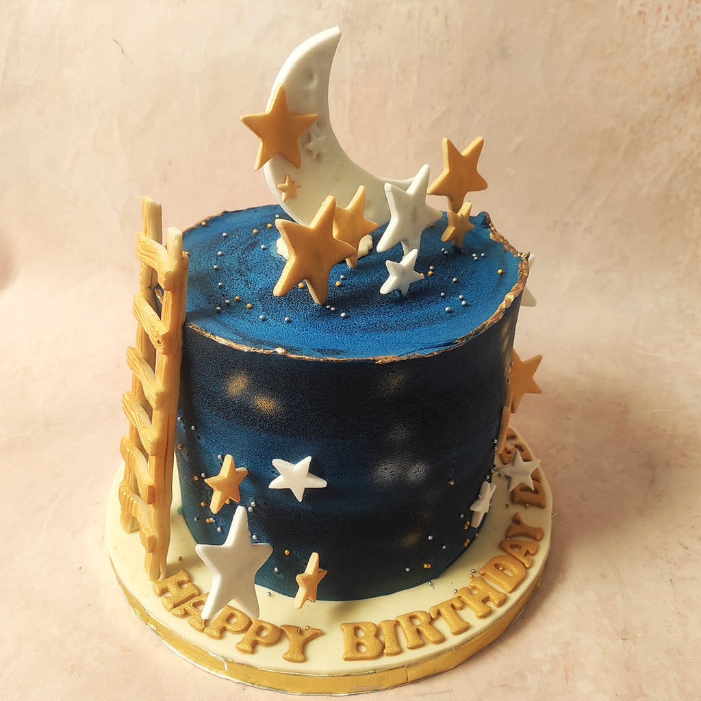 As your gaze ascends, spot the highlight of this Moon and Stars Cake — a pristine white crescent moon.