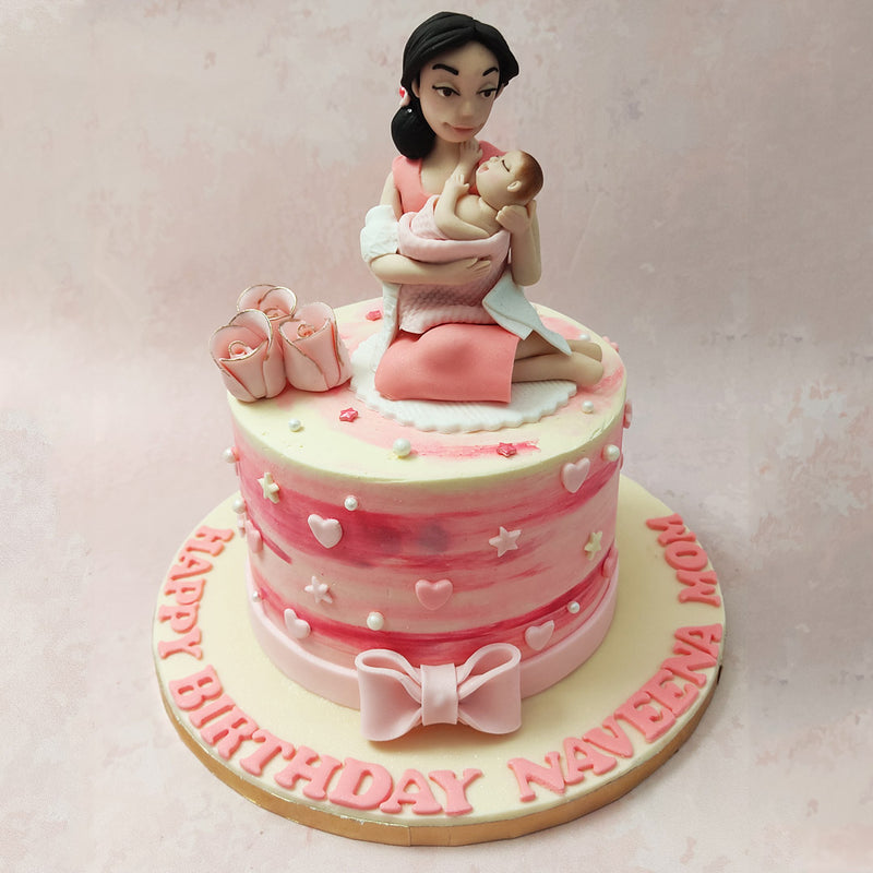 An ombre gradient is used for the base of this mom and daughter birthday cake. In the colour palette of soft pink to white, the hues are further complemented by the embellishment of hearts and stars.