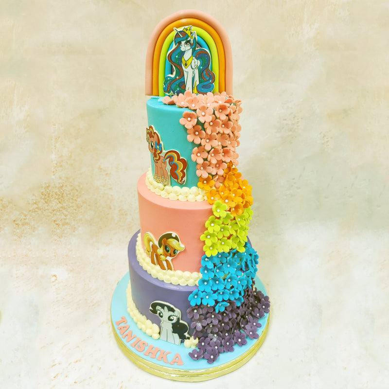 The crowning glory of this My Little Pony 3 Tier Cake features a rainbow arch reminiscent of Rainbow Dash's sonic rainboom, complete with a detailed unicorn character that captures the majestic spirit of the series' magical equines. 