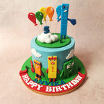 Against a light blue sky where fluffy white clouds dance, spot rolling green hills at the bottom of this Numberblocks Cake.