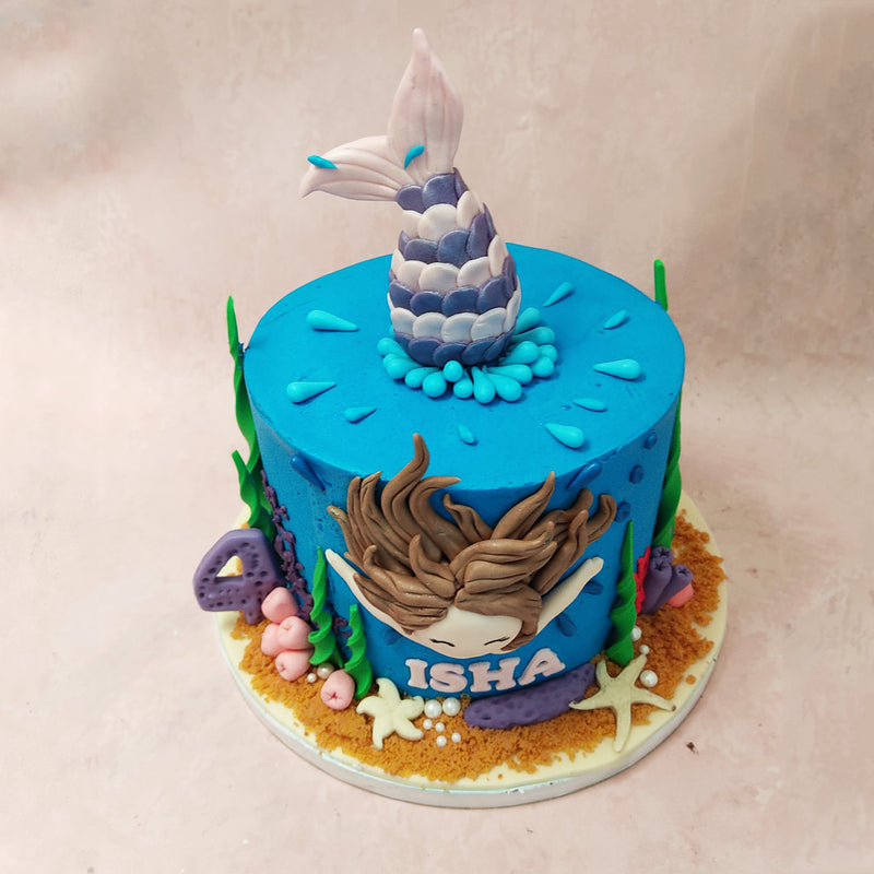 The mermaid's tail sticks out from the top of this ocean cake, creating a stunning visual effect that will leave your child and their guests in awe. 