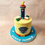 A bright yellow base with clouds and the logo of the show is the set of our Paw Patrol Lookout Tower Cake 