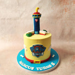 A red edible collar, a nod to Chase's distinctive style, wraps around the bottom of this Paw Patrol Theme Cake, setting the Paw Patrol tone.