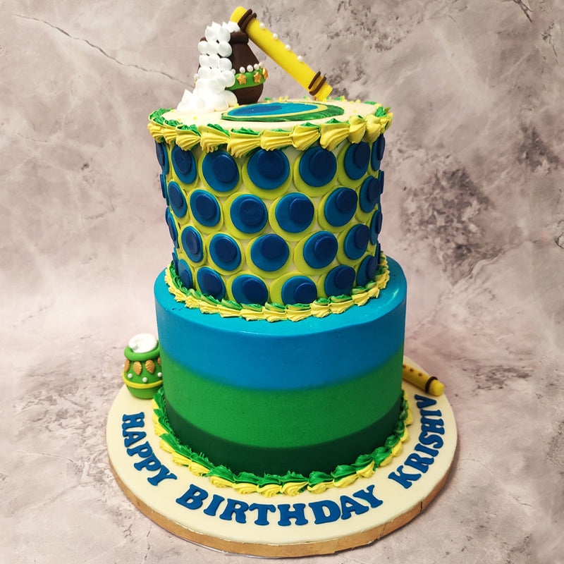 Adorning the top and bottom of this Krishna birthday cake is Krishna's flute and the iconic dahi handi that he would steal during his childhood.