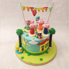 Marking the centrepiece of this Peppa Party Cake are edible figurines of Peppa and her familyall gathered to celebrate with cake, balloons and banner flags. 