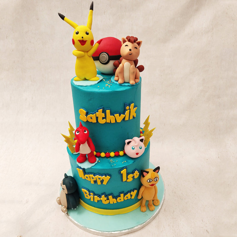 Surrounding the Pokeball cake are popular Pokémon figurines, carefully placed to create an immersive experience for your little one. 