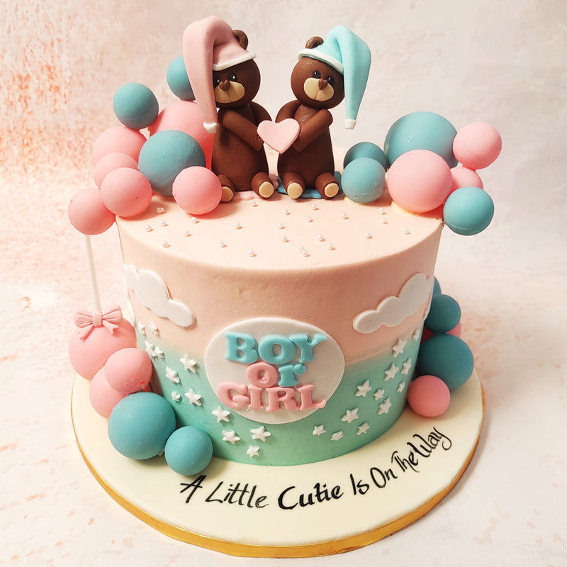 The centrepiece of this Pink and Blue Cake showcases the phrase "Boy or Girl," surrounded by delicate white stars and fluffy clouds, creating a dreamy and whimsical atmosphere.