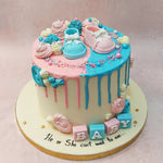 The pink, white and blue layers of this he or she cake create a playful imagery of a popsicle or lollipop, icons of childhood and youthfulness, which is further enhanced by how this pink and blue drip cake is garnished in colourful sprinkles, baubles and buttercream swirls that resemble cupcake toppings. 