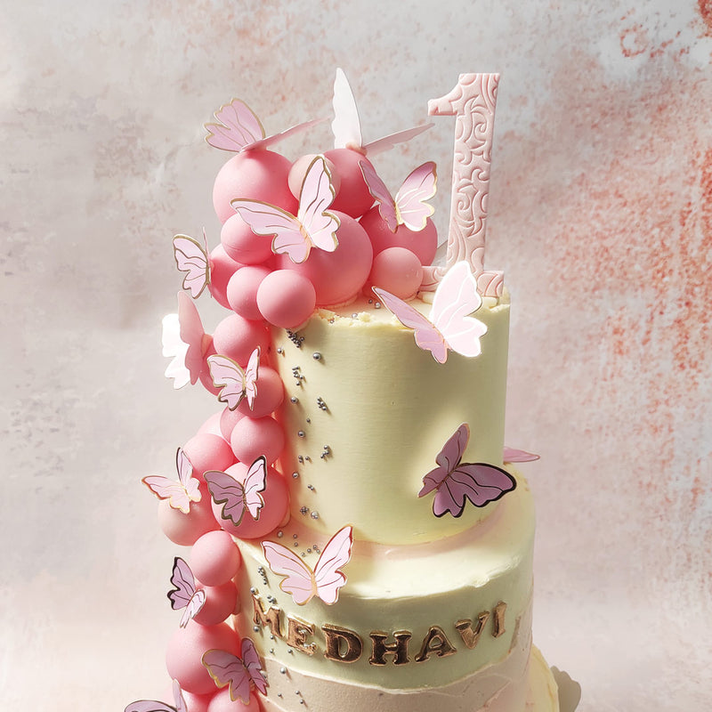 Picture this: creamy tiers adorned with delicate pink fault lines, each tier of this Pink and White Butterfly Cake whispering tales of elegance. 