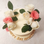Embedded into this pink and white cake are delicate pink and white roses, symbolising grace, admiration, and appreciation. 