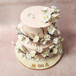The soft and elegant light pink hue of this pink cake with white flowers represents love, tenderness, and affection. 