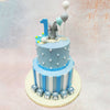 This Playful 2 Tier Elephant Cake features an adorable pachyderm figurine as its centrepiece, perched thoughtfully amongst the balloon topped elements that add height and whimsy. 