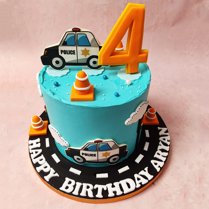 Traffic cones and signals join forces, balanced by two police cars, promising a sugary adventure that's arresting in every bite of this Police Car Cake design.