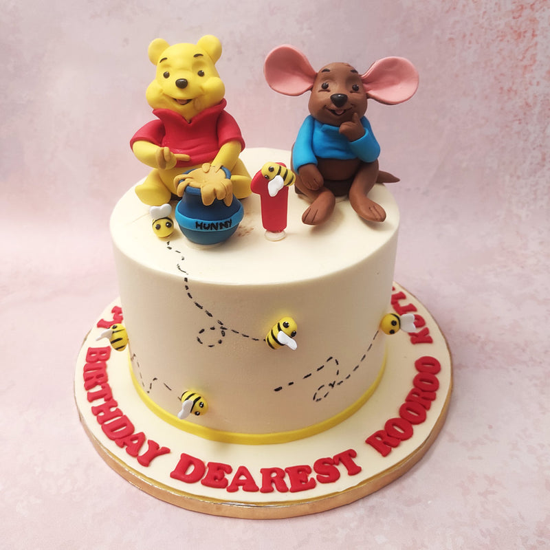 At first glance, the white base of this Pooh and Roo cake represents purity and innocence, reflecting the innocence of childhood. 